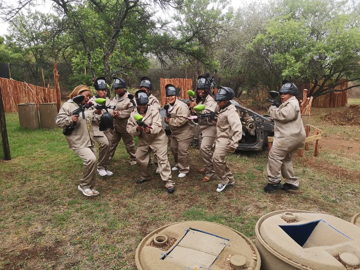 A corporate team geared up on the paintball field at Legends